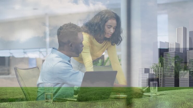 Animation of clouds, low angle view of grass and buildings on diverse coworkers discussing in office