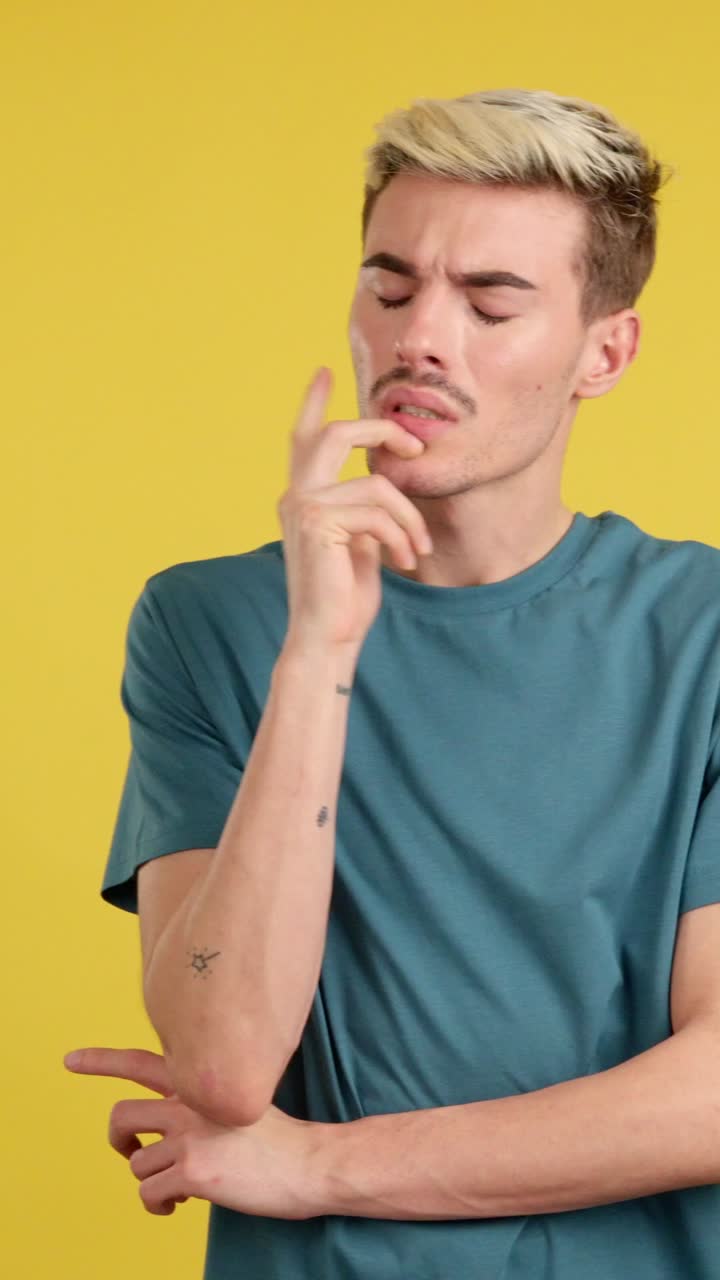 Man thinking in front of yellow background