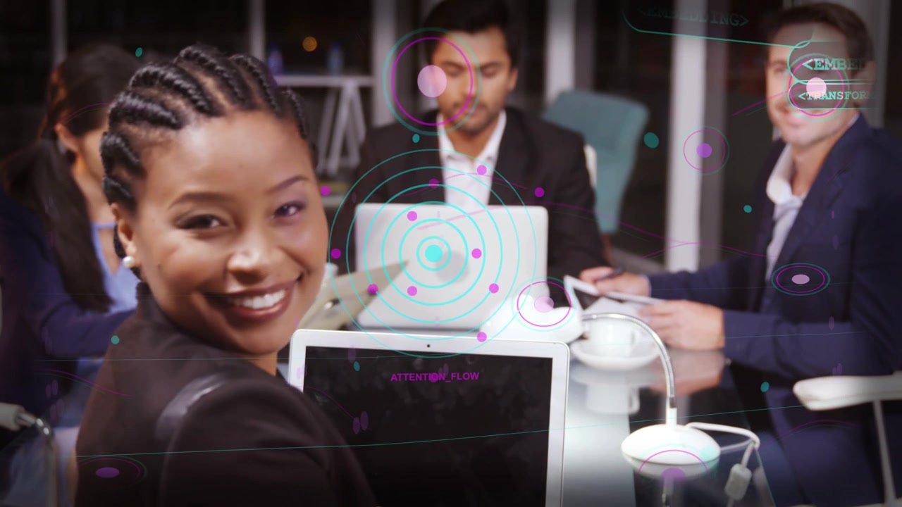 Braided-speaker leading biz meeting, addressing team, gesturing, UI centering on laptop for review