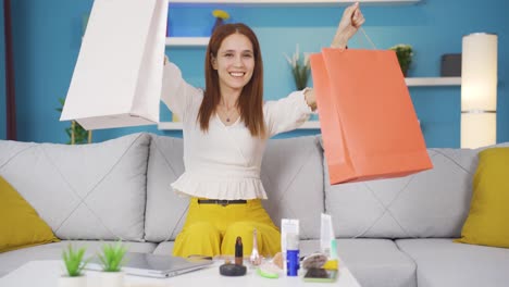 mujer joven bailando con bolsas de compras.
