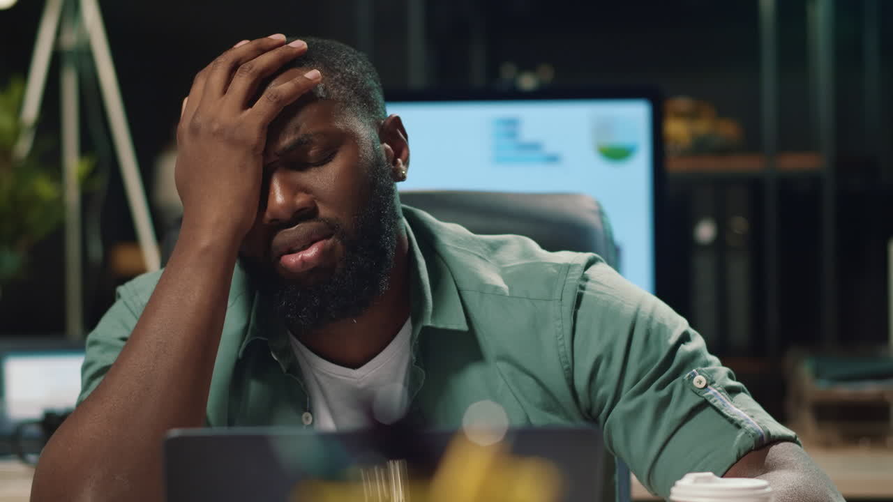 Closeup upset african american businessman finding mistakes in project indoors.