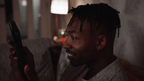 young black male looking closely at tablet device