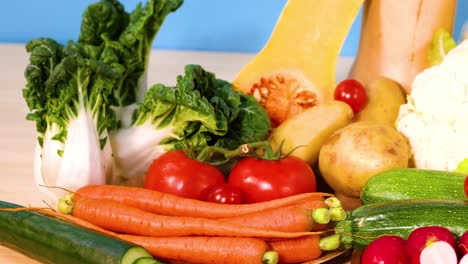 assorted vegetables arranged against a blue background