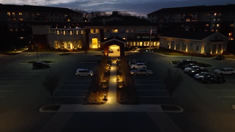 aerial tilt up reveal of american retirement community at night