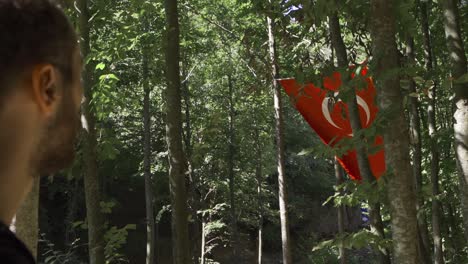 Young-man-looking-at-Turkish-Flag-in-slow-motion.