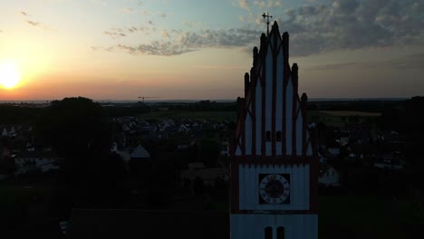 golden hour background illuminating church spire and clock