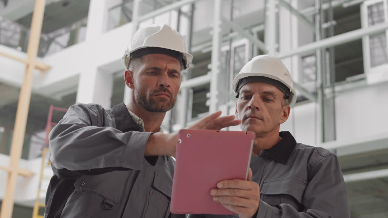 Caucasian Builders Using Tablet Computer