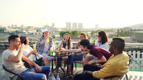 friends celebrating on rooftop terrace