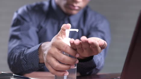 man applying hand sanitizer