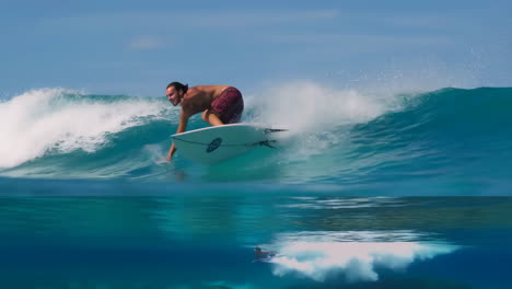 surfer riding majestic blue waves with underwater perspective