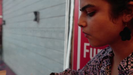 Close-up-shot-of-a-South-Asian-girl-eating-a-sandwich