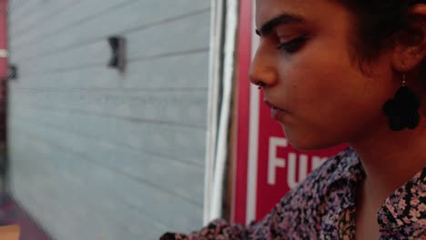 close-up shot of a south asian girl eating a sandwich