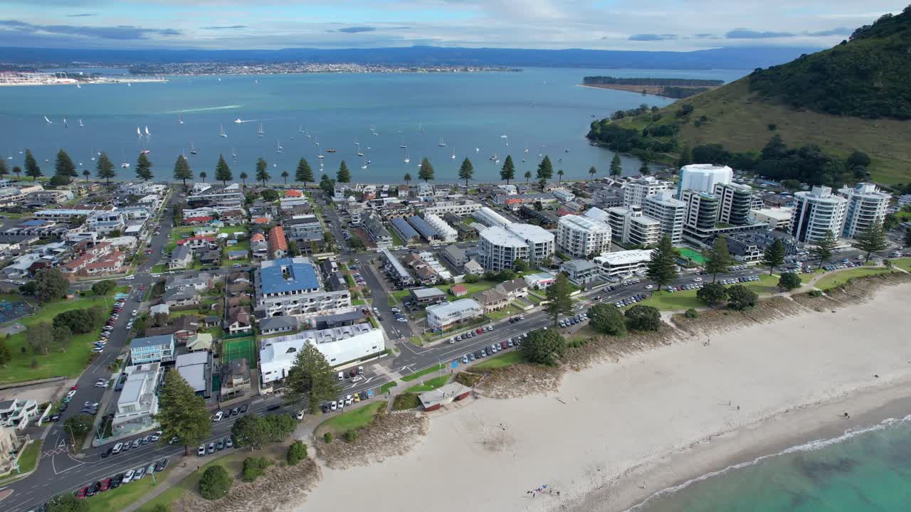 Aerial view of Mount Maunganui, New Zealand, showcasing the beach, town, and harbor