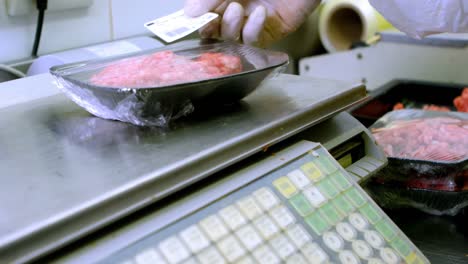 butcher weighing minced on weighing machine in butchers shop 4k