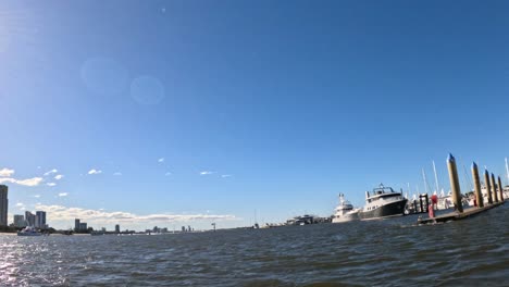 yachts docked with city skyline in background