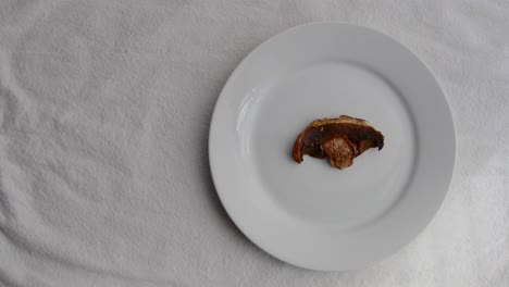 Dried-Porcini-mushroom-on-white-ceramic-tableware-on-white-table-mat