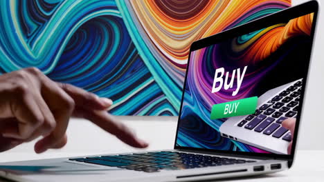 finger poised over laptop keyboard with 'buy' button on screen