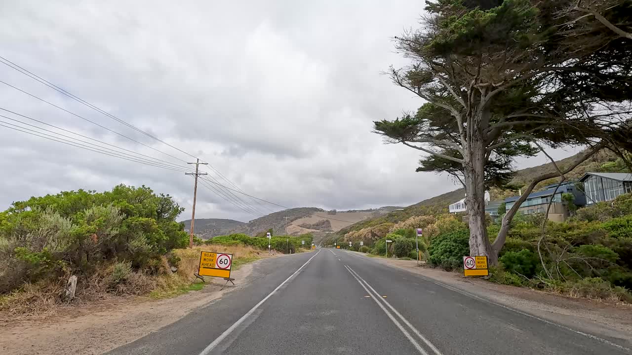 A 30-second drive showcasing the picturesque Great Ocean Road with lush landscapes and coastal views