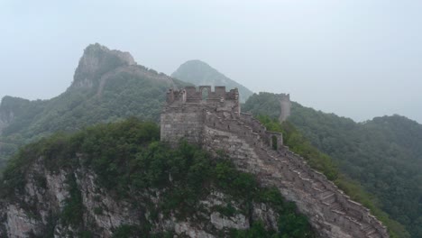 fly over the mountain ridge with old part great wall of china on top