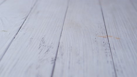 cleaning a ketchup spill from a wooden table