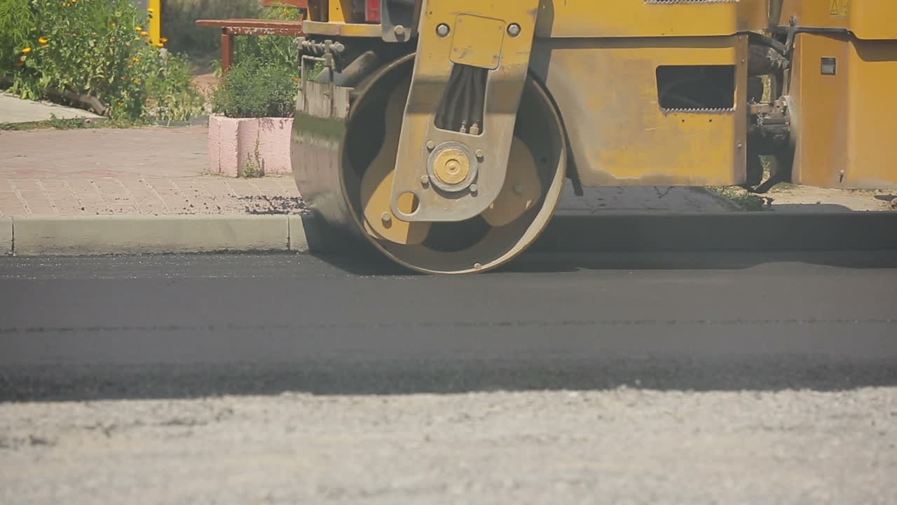Road roller working on the new road construction site