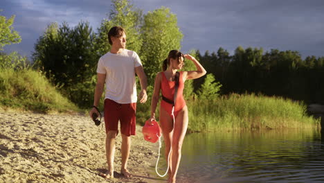 young man and woman working at the beach