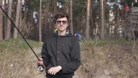 a young guy catches a predatory fish on spinning from the shore. fishing as a hobby.