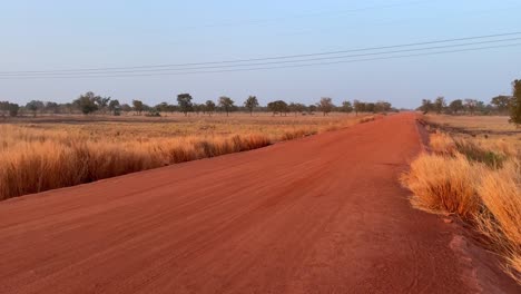 panoramic-view-of-red-sand-road-in-Wulugu-village,-Northern-Ghana,-classic-typical-africa-landscape