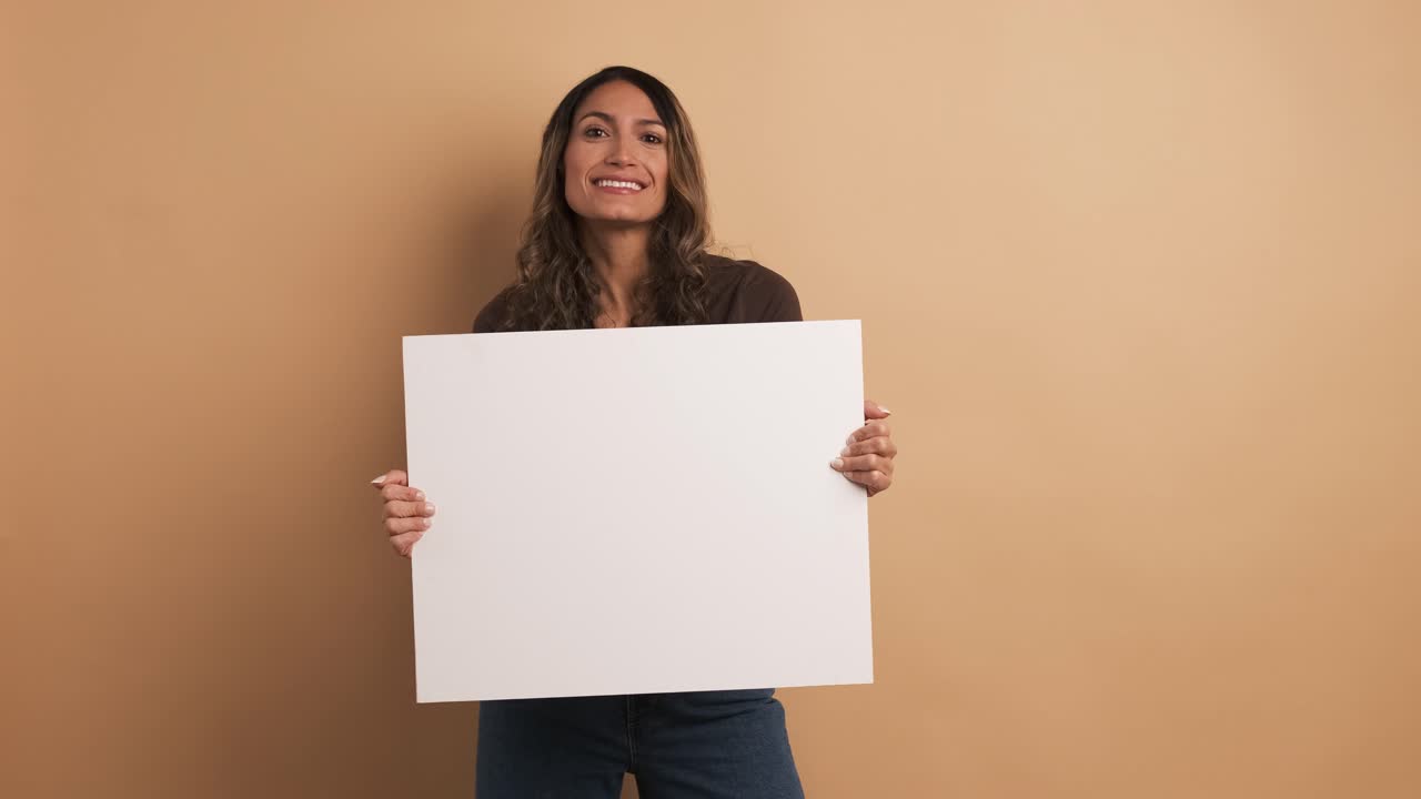 Woman holding a blank panel while smiling at the camera
