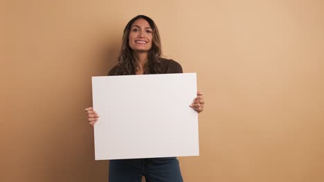 woman holding a blank panel while smiling at the camera