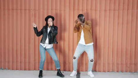 stylish dancing couple in urban setting