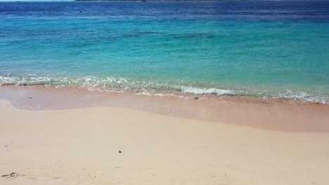 Island-In-Maldives---Crystal-Blue-Sea-Water-Waves-Calmly-Splashing-To-The-Sandy-Shore-With-Beautiful-Coral-Reef-Underwater---Closeup-Shot