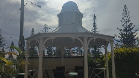 pan up, spa bath bubbling with poolside arbour and early morning sky in background.