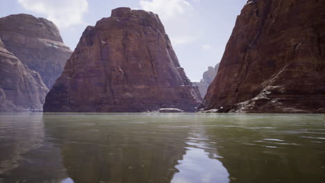 majestic rock formations reflected in tranquil water at a scenic canyon