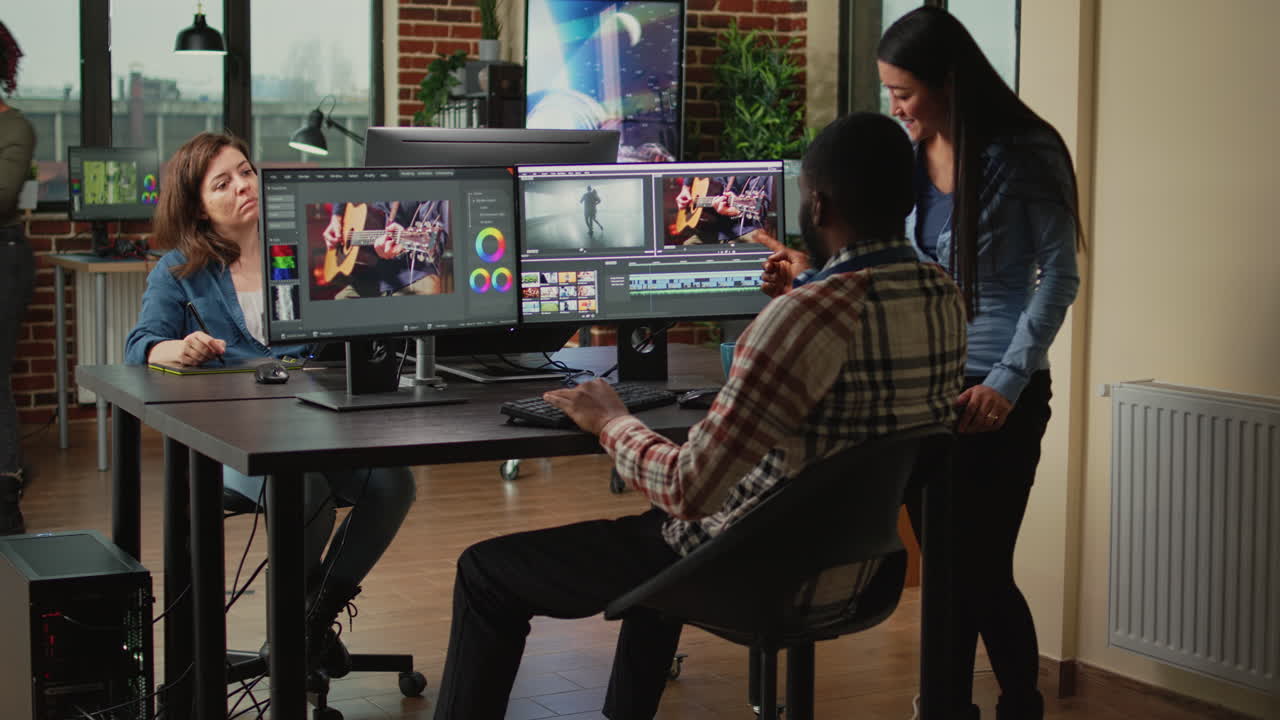 Team of artistic content creators editing movie montage on software