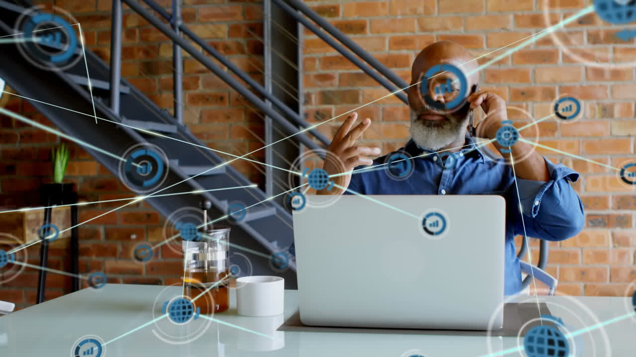 Animation of network of digital icons over african american man talking on smartphone at office