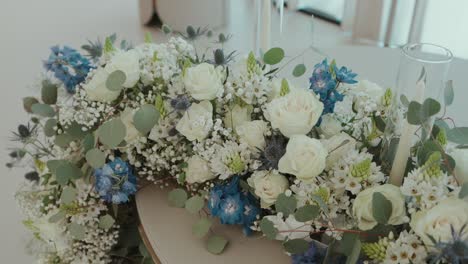 elegant floral centerpiece with white roses and blue blossoms
