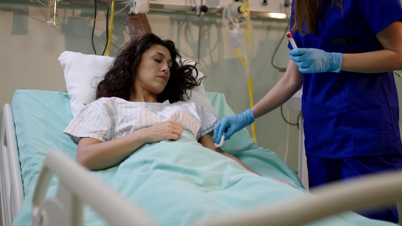 Patient Receiving Blood Draw in Hospital Bed