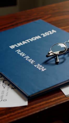 office desk with calendar, glasses and pen