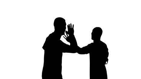 Video-of-black-silhouettes-of-two-male-soccer-players-cheering-isolated-on-white-background