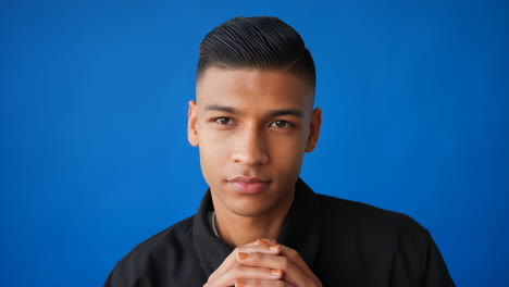 Young Man's Portrait Against a Blue Background