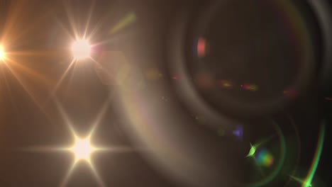 animation of spotlight with lens flare and light beams moving over dark background