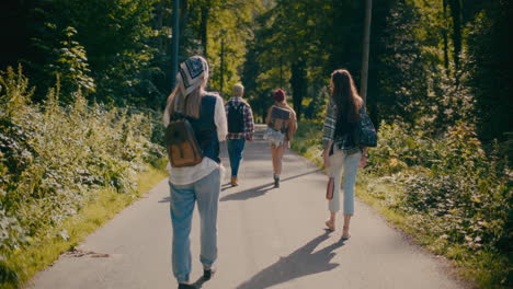 friends walking on footpath amidst forest during vacation