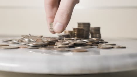 placing a small stack of quarters among other change