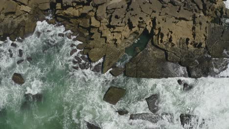 top down view waves breaking at the beach of ericeira in portugal