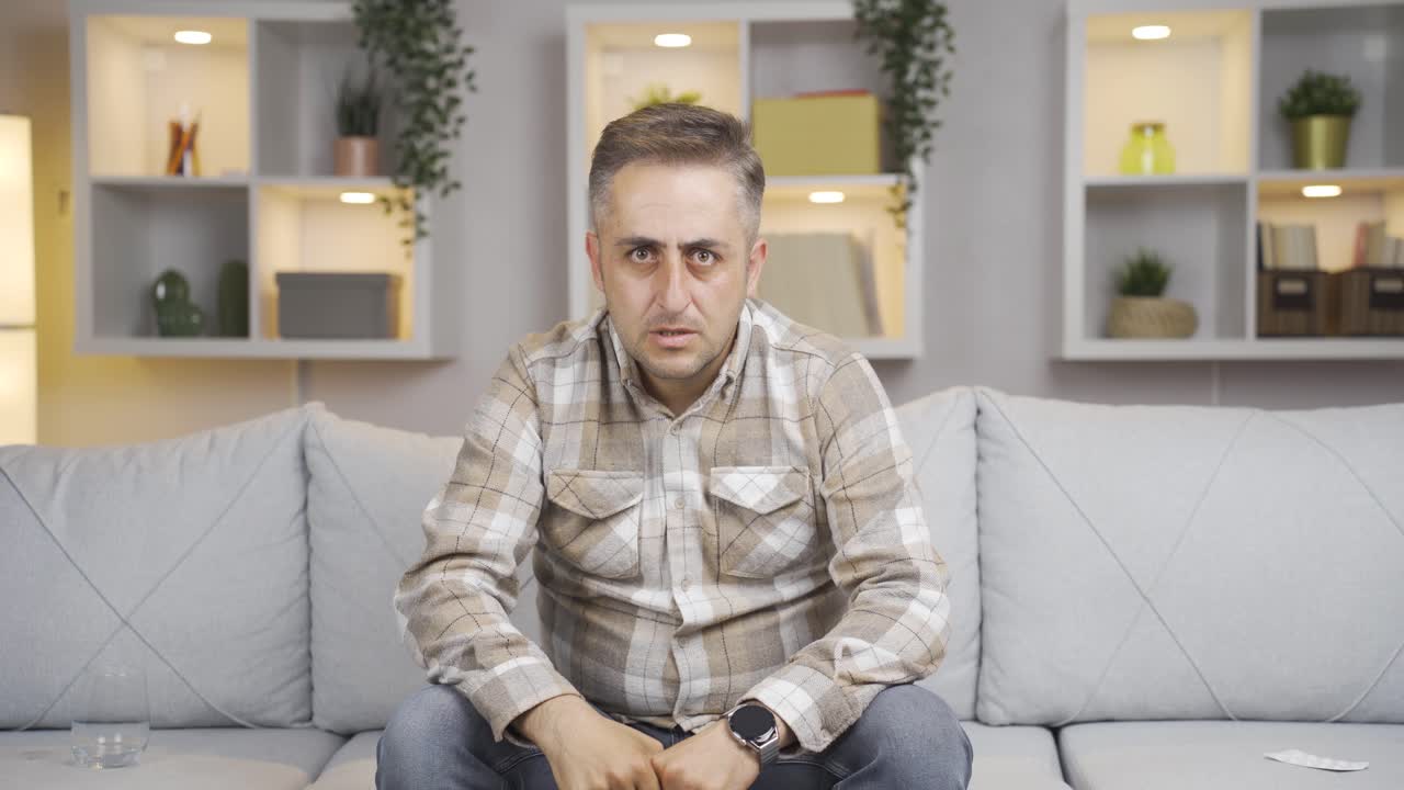 hombre mirando negativamente a la cámara.