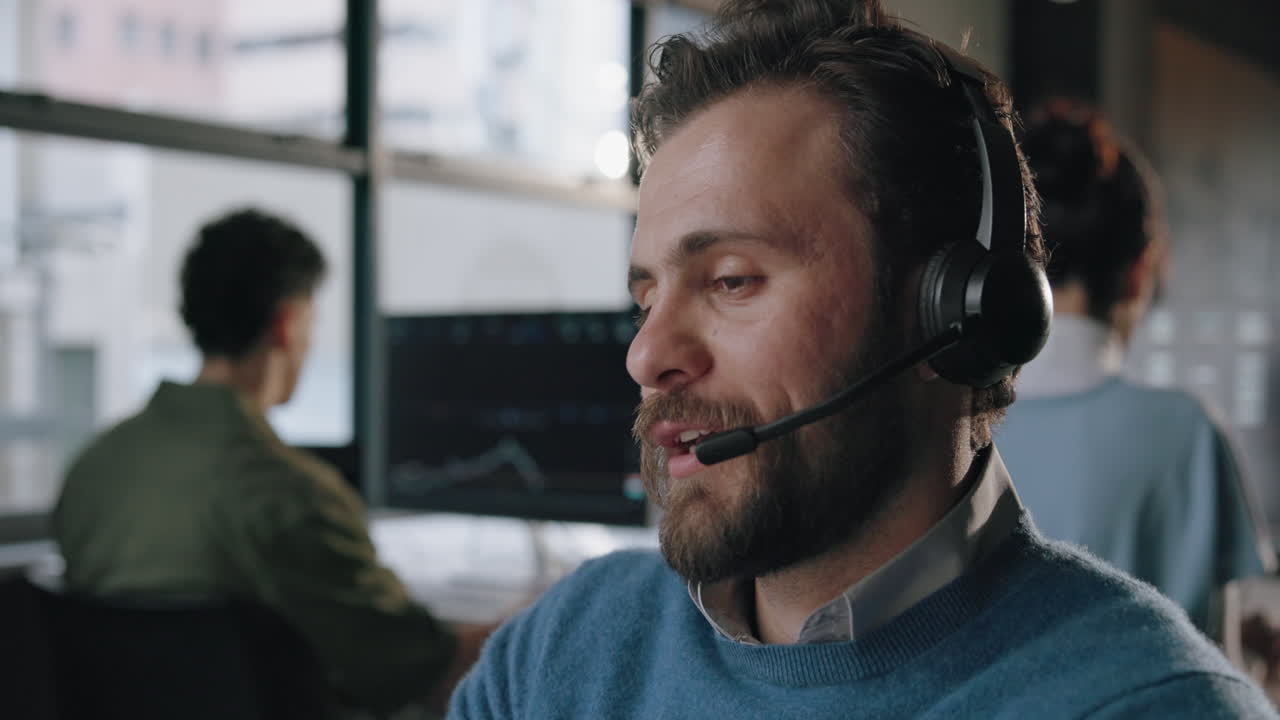 A man wearing a headset working in a call center