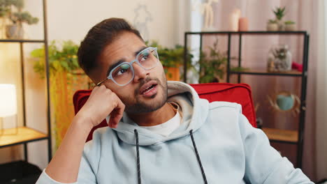 indian man at home suffers from unfair situation problem break up depressed feeling bad burnout