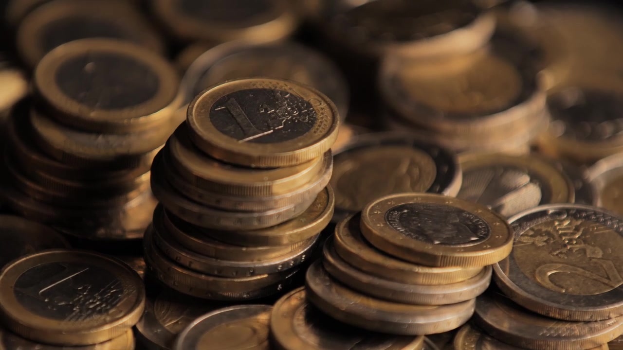 Close-up of stacked coins with golden glow, representing financial stability, 4K