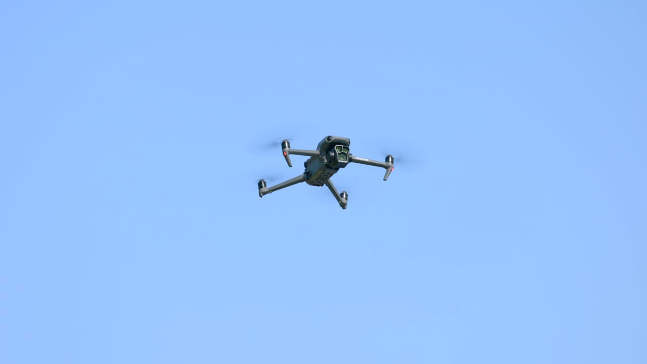 Drone Hovering Against Clear Blue Sky